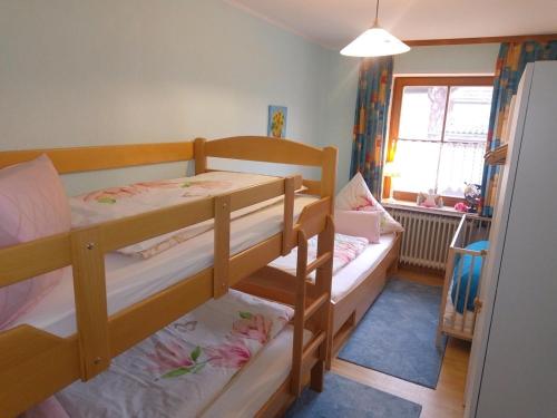 a bedroom with two bunk beds and a window at Im Haus am Ries in Ehingen am Ries