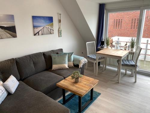 ein Wohnzimmer mit einem Sofa und einem Tisch in der Unterkunft Strandnah in Wenningstedt in Wenningstedt-Braderup