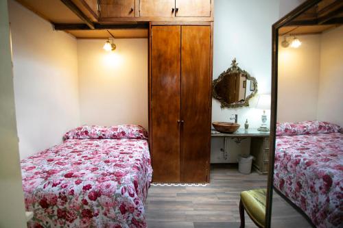 a bedroom with two beds and a mirror at Majikal B&B - La Doña in Cholula