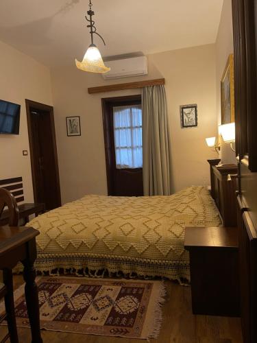 a bedroom with a bed and a window at Hotel Mangalemi in Berat