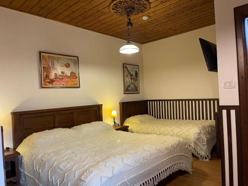 a bedroom with two beds in a room at Hotel Mangalemi in Berat