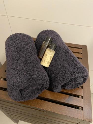 a pair of grey towels sitting on a wooden shelf at Ferienwohnung Gasser in Ebringen