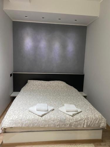 a bedroom with a bed with two towels on it at Apartments Jankovic in Belgrade