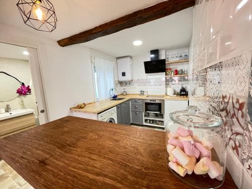 a kitchen with a wooden table with a bowl of food at Bertoko Urdaibai II in Bermeo