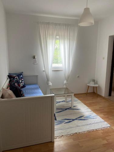 a bedroom with a bed and a window at Apartmani Darko in Kornić