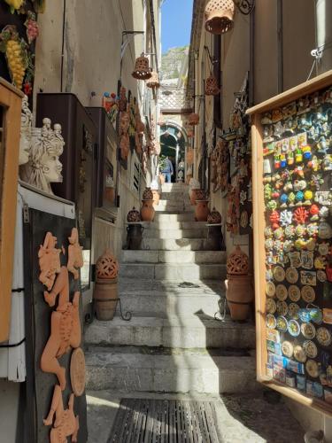 a narrow alley with stairs leading down to a store at Athena Charming Rooms in Taormina