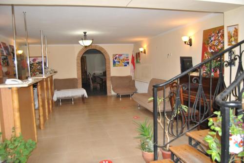 a hallway with a living room and a dining room at Galavnis Kari Hotel in Sighnaghi