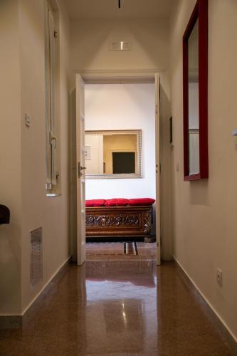 a hallway with a red bed in a room at Abate Luxury Interno 3 in Bari