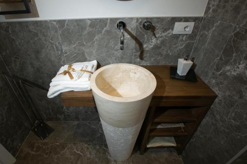 a bathroom with a marble sink and a shower at Abate Luxury Interno 3 in Bari