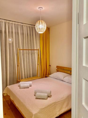 a bedroom with a bed with two towels on it at Chalet Kvariati in Kvariat'i