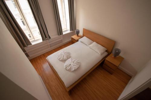 a bedroom with a bed with two pillows on it at Old Compton Street in London