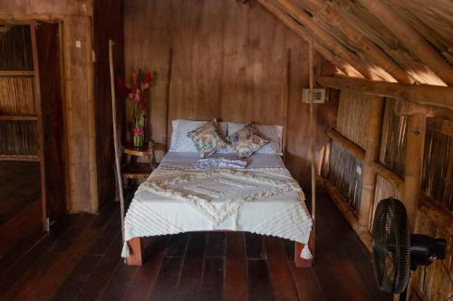 a bedroom with a bed in a wooden room at Kanta Sana in Palomino