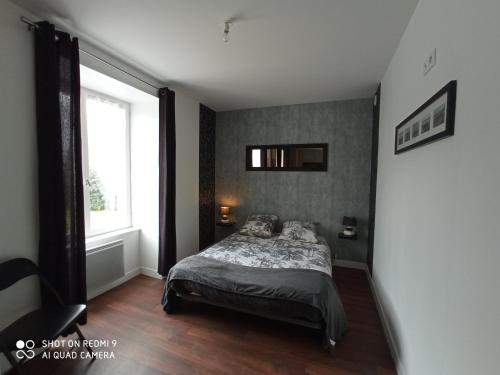 1 dormitorio con cama y ventana grande en LE P'tit logement de lor'Phée, en Chantepie