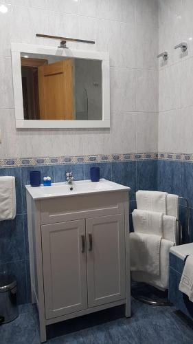 a bathroom with a white sink and a mirror at La Casa del Valle in Soncillo