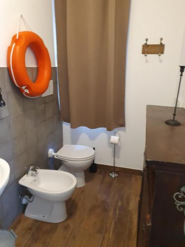 a bathroom with a toilet and a sink at VILLA VILLACOLLE in Procchio