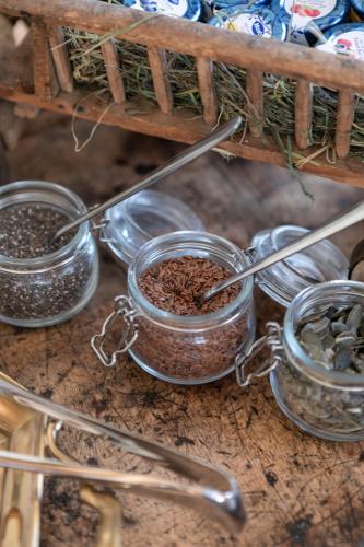a bunch of glass jars filled with seeds on a shelf at B&B Il Tabià in Pieve di Cadore
