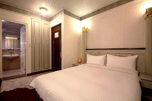 Ένα ή περισσότερα κρεβάτια σε δωμάτιο στο Traveler Hotel Taitung