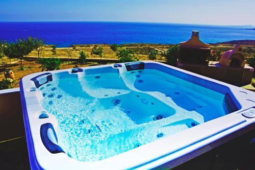 a hot tub with a view of the ocean at Ardani paradise view villa with jacuzzi in Amoopi