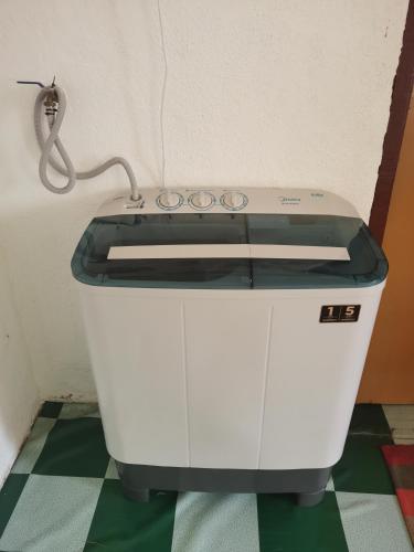 a white sewing machine sitting on a floor at Homestay Che Kiah in Kuantan