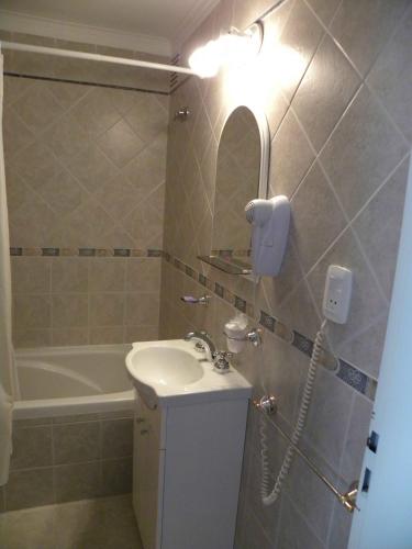 a bathroom with a sink and a phone on the wall at 5ta Bajada Las Grutas in Las Grutas