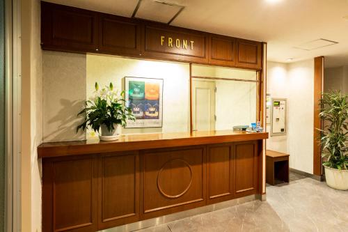 a hotel lobby with a front desk with a mirror at Hotel Liberty Matsuyama (Adult Only) in Matsuyama