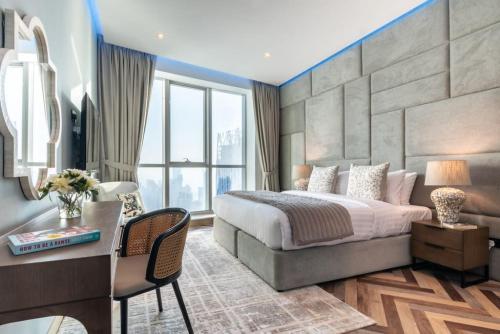 a bedroom with a king sized bed and a desk at Key View - Torch Tower in Dubai