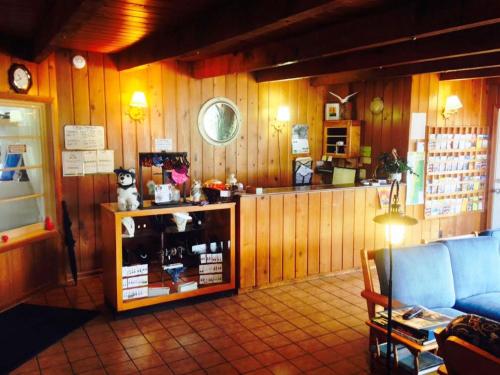 a room with a store with wooden walls and a couch at Tillicum Beach Motel - Formerly Deane's Oceanfront Lodge in Yachats