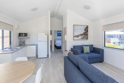 a kitchen and a living room with a couch and a table at Burleigh Beach Tourist Park in Gold Coast