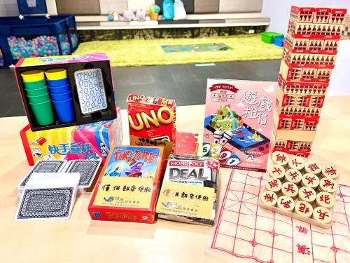 a table topped with lots of games and books at Meci Hotel in Hualien City