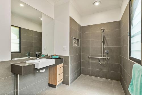 a bathroom with a sink and a shower at Kimberleyland Waterfront Holiday Park in Kununurra