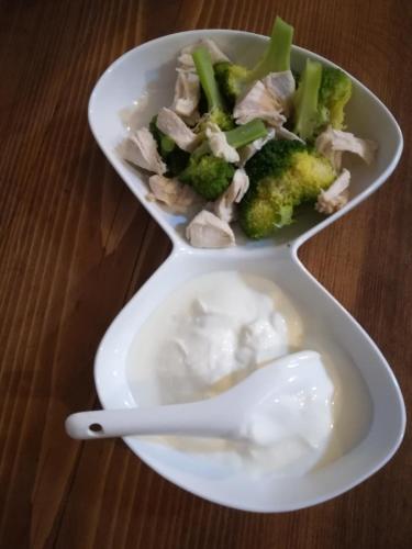 two white dishes with chicken and broccoli on a table at Golden Gate in Akhaltsikhe