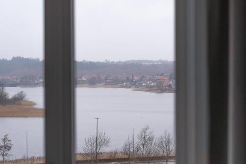 a view of a lake from a window at Hotel Dania in Silkeborg