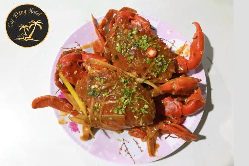 a plate of food with shrimp and other foods at Nhà nghỉ Cát Đằng Hồ Tràm in Ho Tram