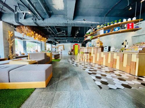 a room with couches and tables in a store at Meci Hotel in Hualien City