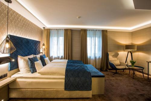 a hotel room with a bed and a chair at Landgasthof Kleiner in Sundern