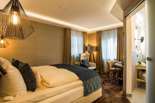a hotel room with a bed and a desk at Landgasthof Kleiner in Sundern