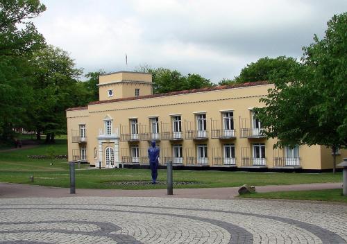a man standing in front of a yellow building at Hotel Dania in Silkeborg
