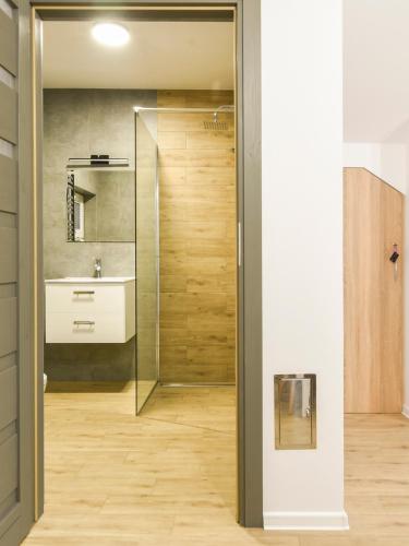 a bathroom with a shower and a sink at Antracytowy Zakątek in Łeba