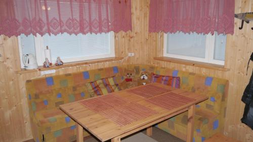 a dining room with a wooden table and chairs at Verlan Satumaa in Verla