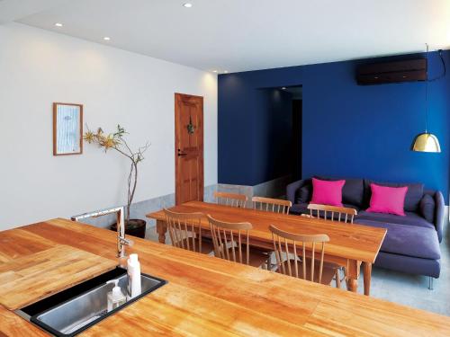 a living room with a table and a couch at CHULAX OKINAWA YOMITAN【Designer Condominium Hotel】 in Yomitan