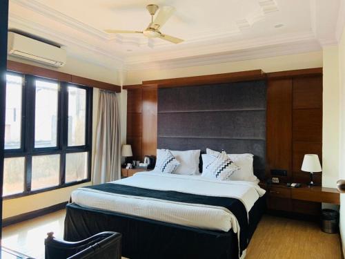 a bedroom with a large bed in a room at The Mark Hotel in Kolkata