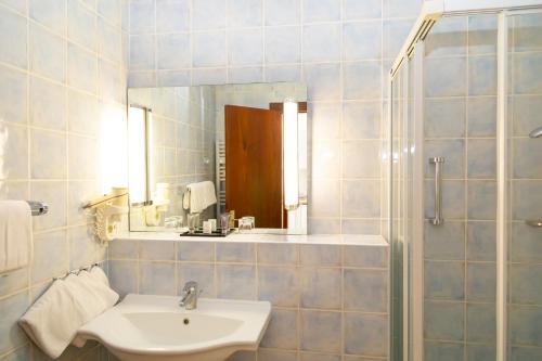 a white bathroom with a sink and a mirror at Hapimag Apartments Antibes in Antibes