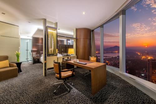 an office with a desk and a view of the city at InterContinental Nanjing by IHG in Nanjing