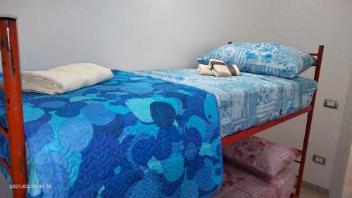 sypialnia z łóżkiem z niebieską kołdrą w obiekcie La casa dei sogni w mieście Pachino