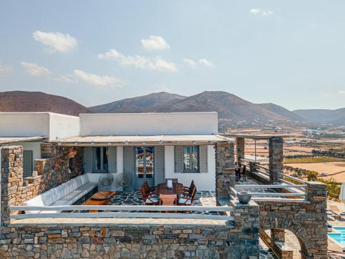 a stone house with a view of the mountains at Terra in Parikia