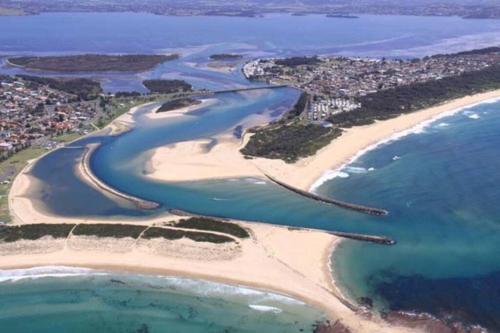 an aerial view of a beach and the ocean at Spectacular Lake and Ocean View Holiday Home in Lake Heights