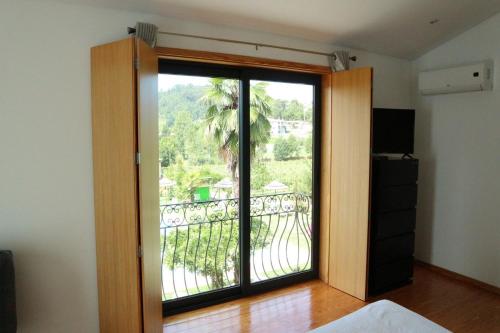 a room with a door with a view of a balcony at Quinta Lama de Cima in Fafe
