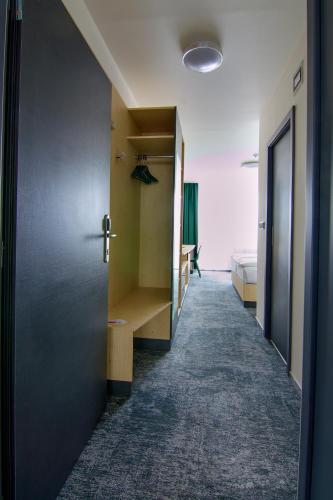 a hallway with a door leading to a bedroom at Hotel Srní a Depandance in Srní