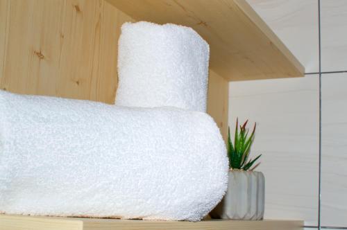 a white blanket sitting on top of a table at Hotel Srní a Depandance in Srní
