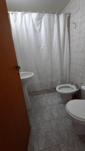 a bathroom with a toilet and a sink at Yaik in San Carlos de Bariloche